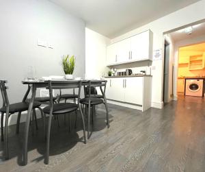 a kitchen and dining room with a table and chairs at Chantry Suites in Grimsby +11 photos