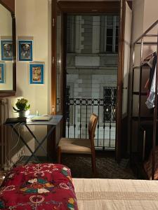 a room with a desk and a chair and a balcony at Ca' Monteggia Guest House in Milan