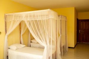 Postel nebo postele na pokoji v ubytování Amazone Hotel Tulear