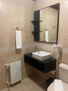 a bathroom with a sink and a mirror at Hotel Glamour da Serra in Gramado