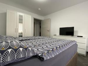 a bedroom with a large bed with a tv on it at Gästewohnung 4 in Oschersleben
