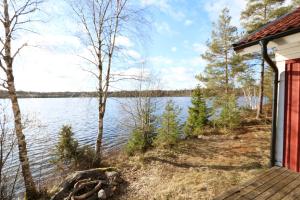 a cabin with a view of a lake at Holiday house in Gnosjo with amazing lake view in Gnosjö