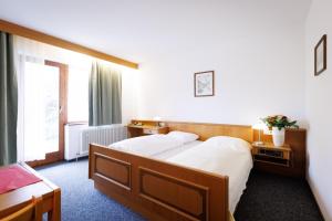 a hotel room with a bed and a window at Naturhotel Blaubach in Blaubach