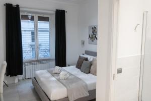 a bedroom with a bed with two stuffed animals on it at Vatican Grand Suite in Rome