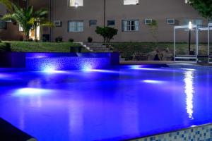 basen oświetlony w nocy niebieskimi światłami w obiekcie Hotel La Huertita w mieście Libertador General San Martín