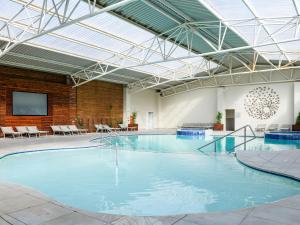 a large swimming pool in a large building at Kiara Lodge in Clarens
