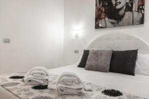 a bedroom with a bed with towels on it at Vatican Grand Suite in Rome