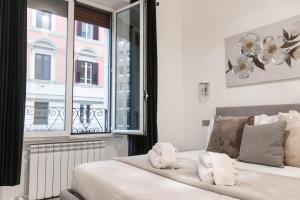 a bedroom with a bed and a window at Vatican Grand Suite in Rome
