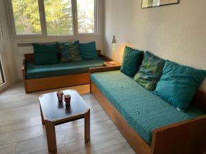 - un salon avec deux canapés verts et une table dans l'établissement Apartment Le Chamois Blanc-3 by Interhome, à Chamonix-Mont-Blanc