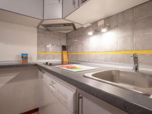 a kitchen with a sink and a counter top at Apartment Balcons D'Olympie-1 by Interhome in Les Menuires