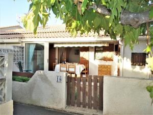 a house with a fence in front of it at Holiday Home L'Hacienda by Interhome in Narbonne-Plage