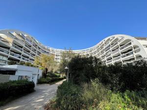 a large white building with domes on the side of it at Studio Ulysse Plage-12 by Interhome in La Grande-Motte