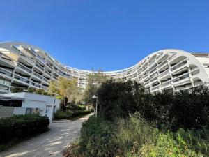 a large white building with domes on the side of it at Studio Ulysse Plage-12 by Interhome in La Grande Motte