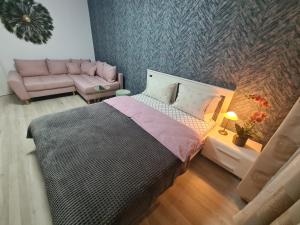 a bedroom with a large bed and a couch at Ghencea Residence 158 Floor 10 in Bucharest +19 photos