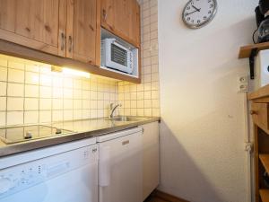 a kitchen with a sink and a microwave at Apartment Brelin-6 by Interhome in Les Menuires