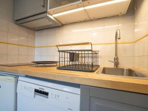 a kitchen with a sink and a dish drying rack at Apartment Balcon d'Olympie 745 - B by Interhome in Les Menuires
