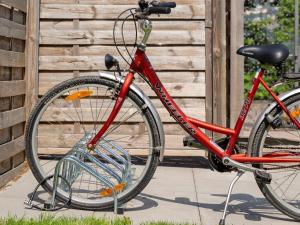 a red bike parked in front of a building at Apartment Resort al Centro-1 by Interhome in Massagno