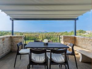 a table and chairs on a balcony with a view at Holiday Home Casa Nini by Interhome in Bibali