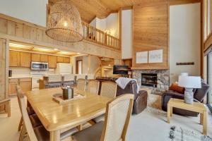 a dining room and living room with a wooden table at The Hidden Chalet in Harbor Springs