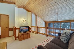 a living room with a couch and a television at The Hidden Chalet in Harbor Springs