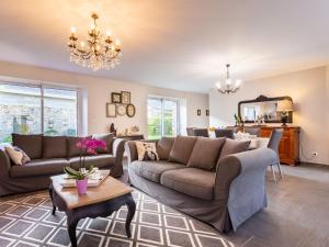 a living room with two couches and a table at Holiday Home La Lucerie - BAY402 by Interhome in Bretteville-sur-Ay