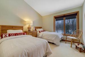 a bedroom with two beds and a window at The Hidden Chalet in Harbor Springs