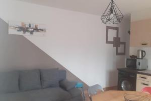 a living room with a couch and a table at Le gîte des cascades in Bassy