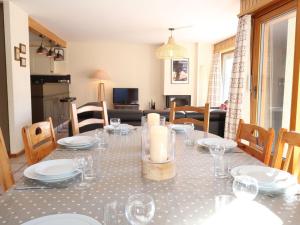 a dining room with a table with plates and wine glasses at Apartment Dents Rousses B4 by Interhome in Siviez