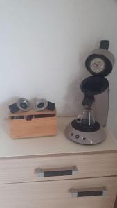 a counter with a clock and a coffee maker at Le gîte des cascades in Bassy