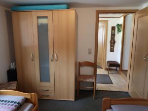 a bedroom with a cupboard and a mirror at Holiday Home Möslehof by Interhome in Vorderfalkau
