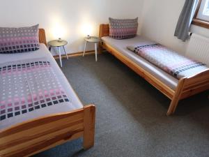 two beds in a room with two tables at Holiday Home Möslehof by Interhome in Vorderfalkau