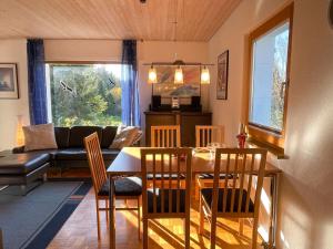 a dining room and living room with a table and chairs at Holiday Home Westfalen by Interhome in Dittishausen
