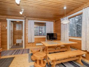 ルカにあるHoliday Home Viipusjärvi 10 by Interhomeの木製のテーブルとベンチが備わる木造の部屋