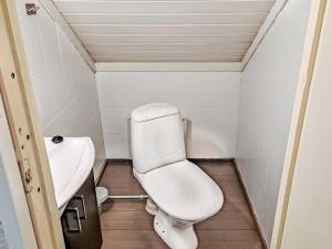 a small bathroom with a toilet and a sink at Holiday Home Pajalan piilopirtti by Interhome in Nissi