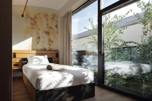 A bed or beds in a room at VERSOVERDE HOTEL Alzaia Naviglio Grande