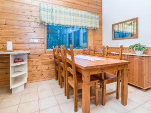 a dining room with a wooden table and chairs at Holiday Home Villa kuukso by Interhome in Kuusamo