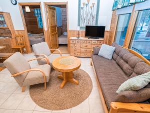 a living room with a couch and chairs and a table at Holiday Home Villa hilla by Interhome in Kuusamo
