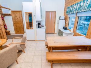 a living room with a table and a kitchen at Holiday Home Villa hilla by Interhome in Kuusamo