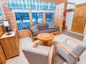 a living room with a couch and chairs and a table at Holiday Home Villa lakka by Interhome in Kuusamo