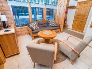 a living room with a couch and chairs and a table at Holiday Home Villa lakka by Interhome in Kuusamo