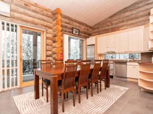 a dining room with a wooden table and chairs at Holiday Home Leija by Interhome in Ruka