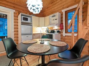 a kitchen with a table and chairs in a cabin at Holiday Home Felixinpolku 2 by Interhome in Ylläsjärvi