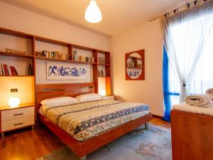 sypialnia z łóżkiem i półką na książki w obiekcie Apartment La Rondine - LUU280 by Interhome w Lukce