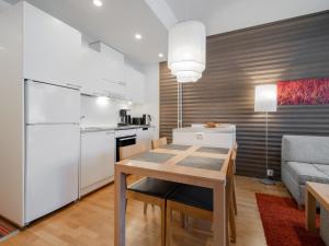 a kitchen and living room with a table and a refrigerator at Holiday Home Nordic chalet 9211 by Interhome in Ylläs