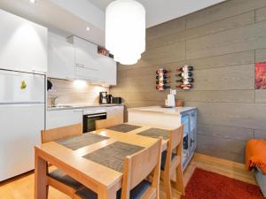 a kitchen with a wooden table and a dining room at Holiday Home Ski chalet vii 7406 by Interhome in Ylläs