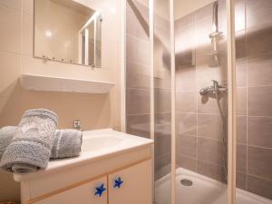 a bathroom with a shower and a sink and a toilet at Apartment Les Lauzes-4 by Interhome in Les Menuires