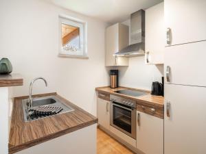 a kitchen with a sink and a refrigerator at Apartment Top 10 by Interhome in Sankt Margarethen im Lungau