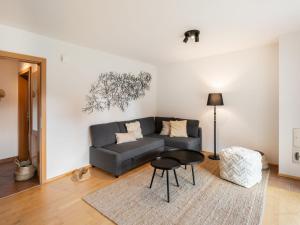 a living room with a couch and a table at Apartment Top 10 by Interhome in Sankt Margarethen im Lungau