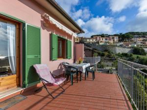 a patio with a table and chairs on a balcony at Apartment Giulia-2 by Interhome in Capoliveri