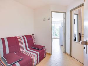 a living room with a couch and a sliding door at Apartment Les Frégates by Interhome in Saint-Cyprien-Plage